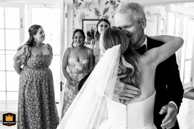 At a private residence in Northeast Harbor, Maine, the bride shares an emotional first look with her dad while getting ready.